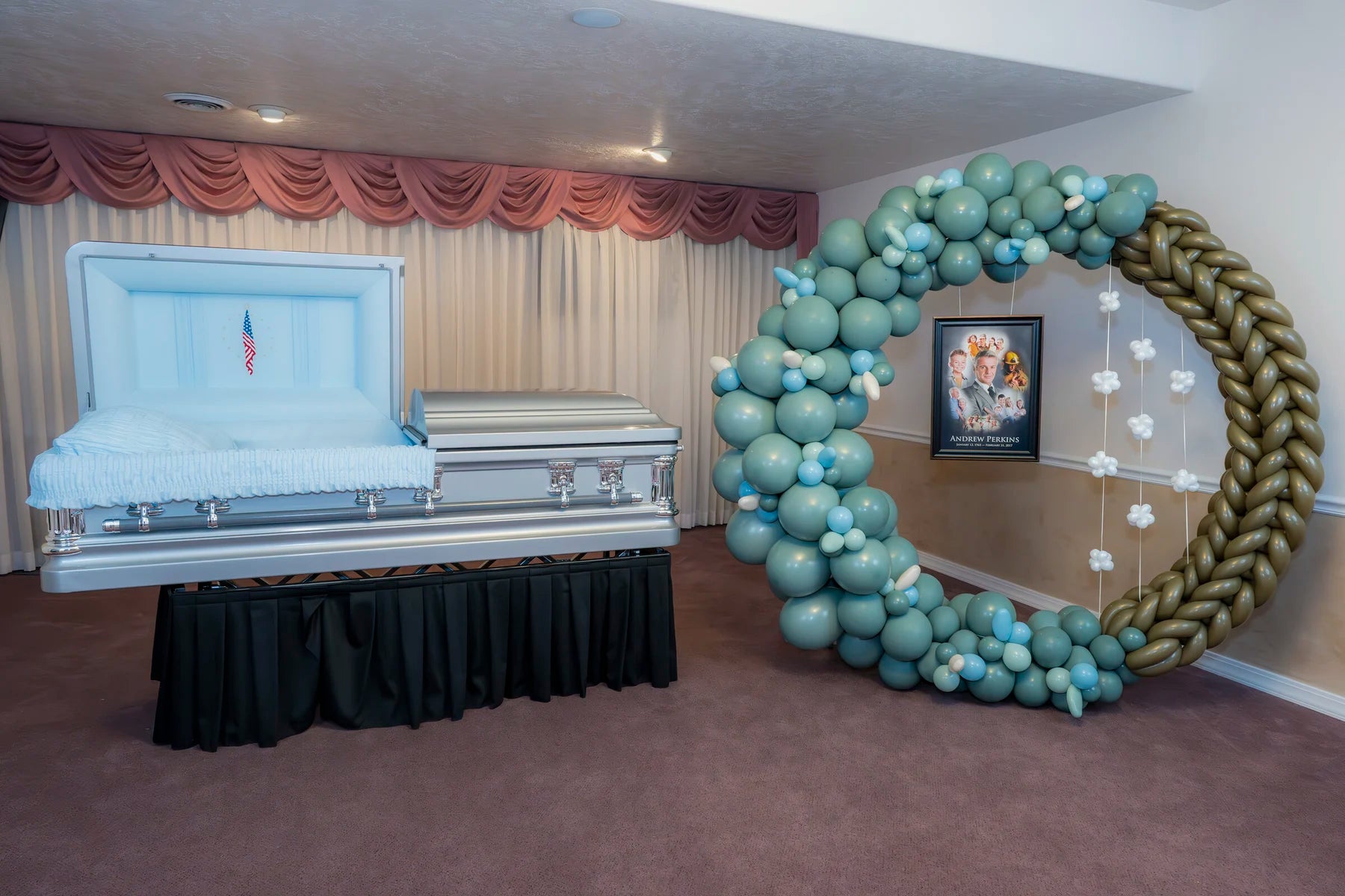 Aqua and champagne halo memorial balloon presentation beside a casket.