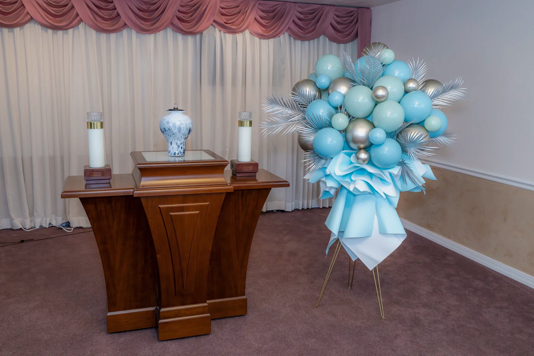 Blue and silver memorial standing arrangement near a pulpit.